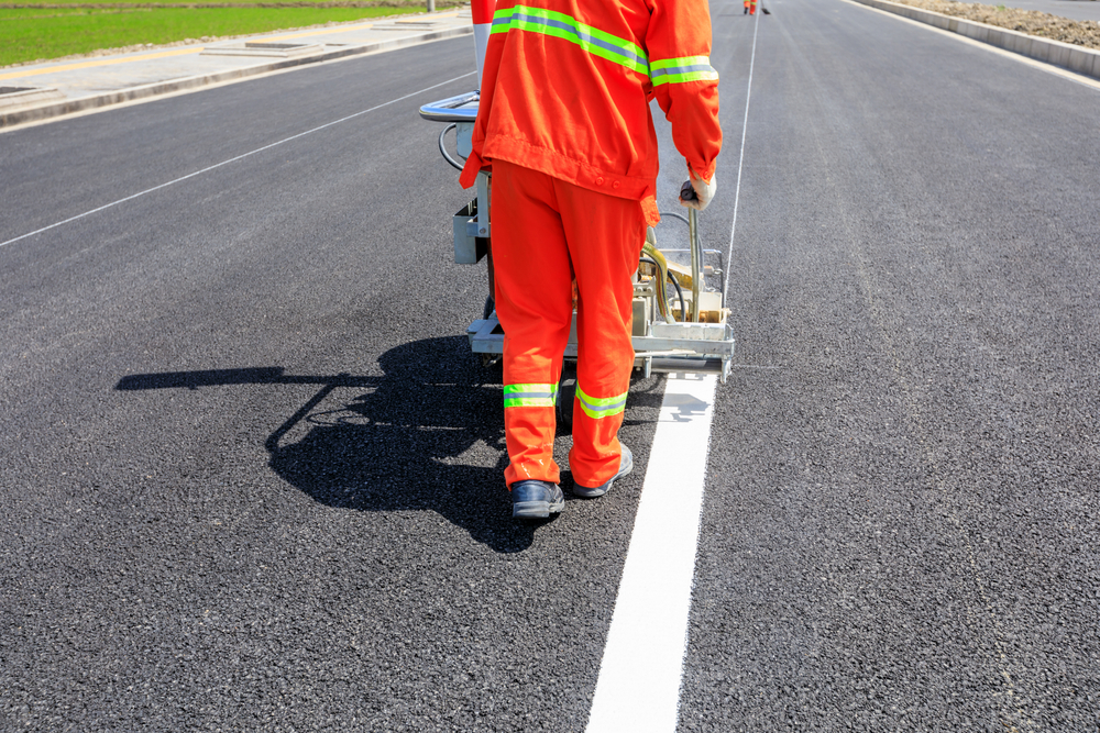 A road marking crew painting fresh white lines on a Hertfordshire road