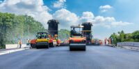 Construction,Site,Is,Laying,New,Asphalt,Pavement,,Road,Construction,Workers