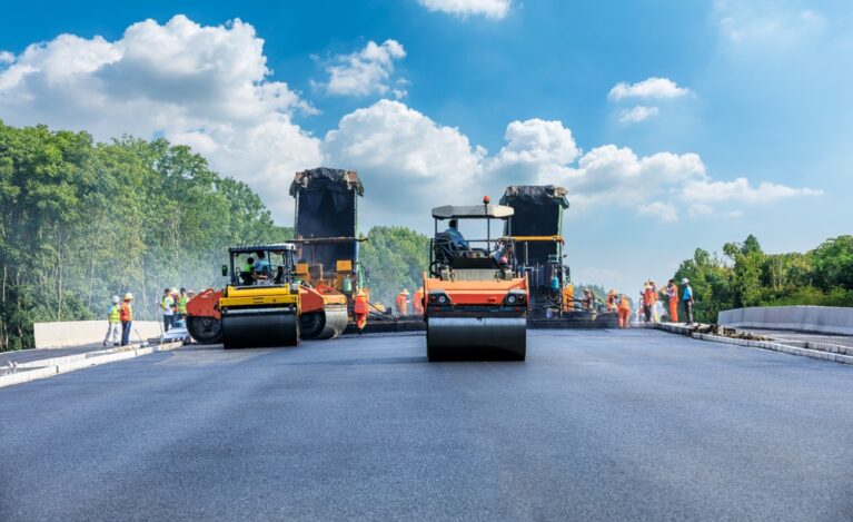 Construction,Site,Is,Laying,New,Asphalt,Pavement,,Road,Construction,Workers