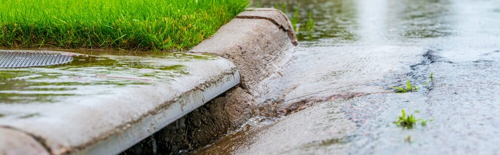 Stormwater,Flowing,Into,Street,Intake,Drain,After,A,Rainstorm