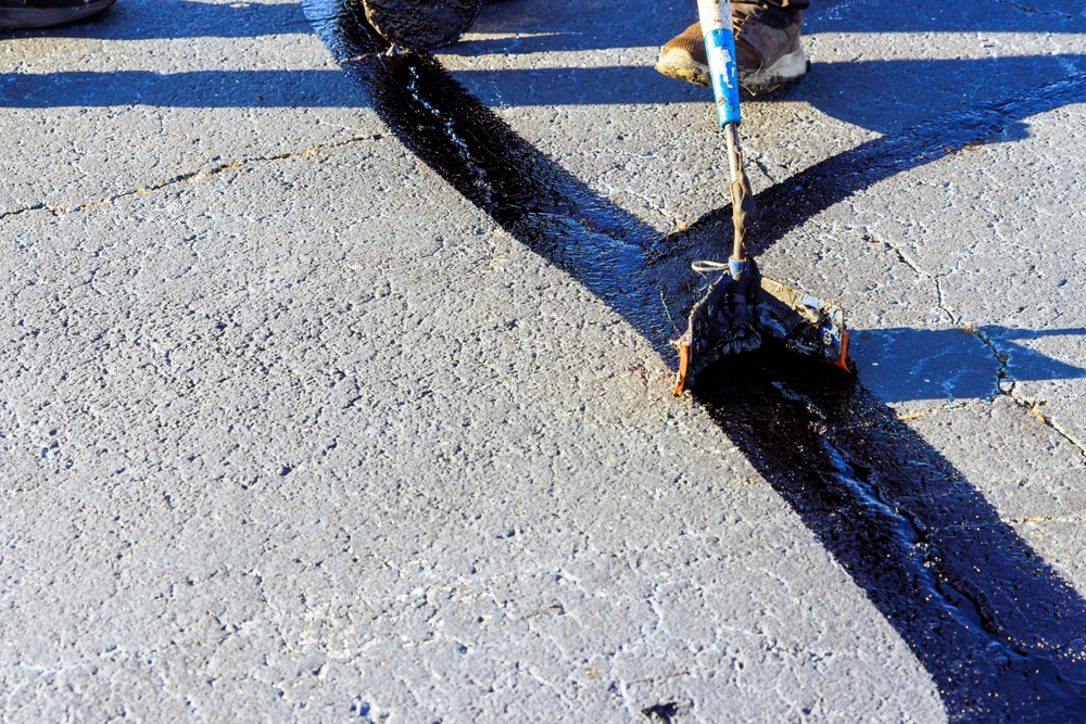 A close-up of a sealed crack on a road surface