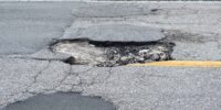 damaged-asphalt-road-with-deep-pothole-on-american-2024-12-06-14-53-17-utc_11zon