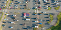 aerial-view-of-many-colorful-cars-parked-on-parkin-2024-12-06-04-35-00-utc