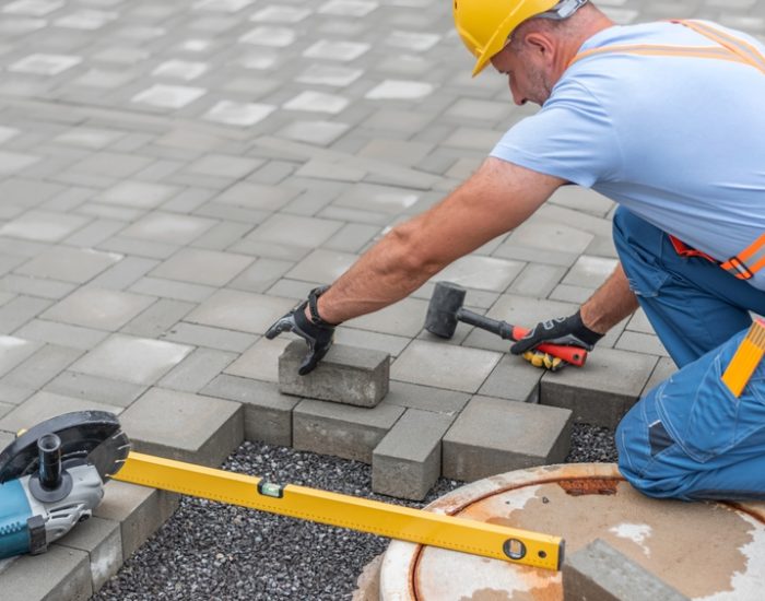 Laying,Interlocking,Paving.,A,Worker,Is,Placing,Interlocking,Paving,Stones
