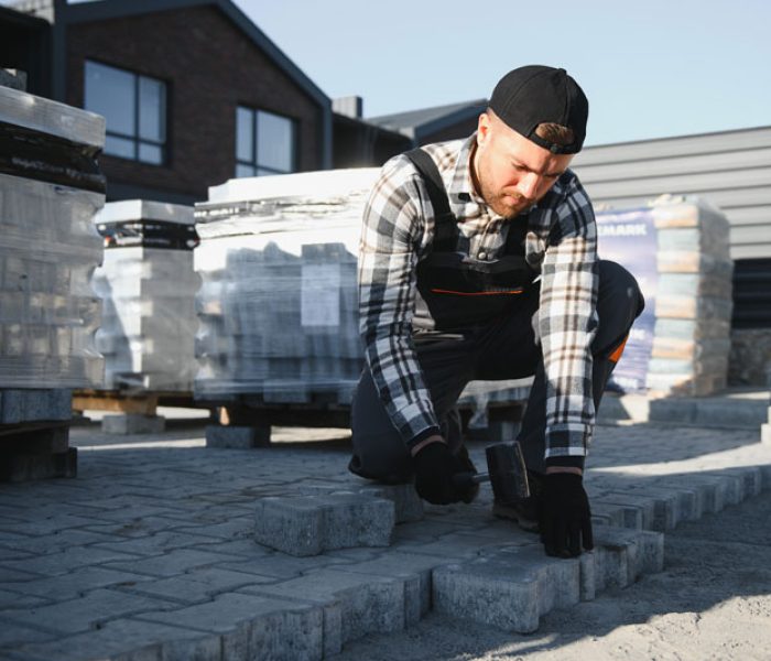 builder-laying-a-paving-brick-placing-it-on-the-sa-2025-10-21-21-56-57-utc